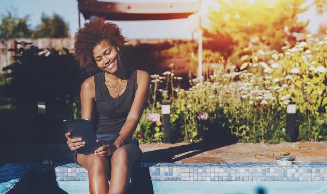 Relax and unwind poolside a woman sitting on a ledge next to a pool