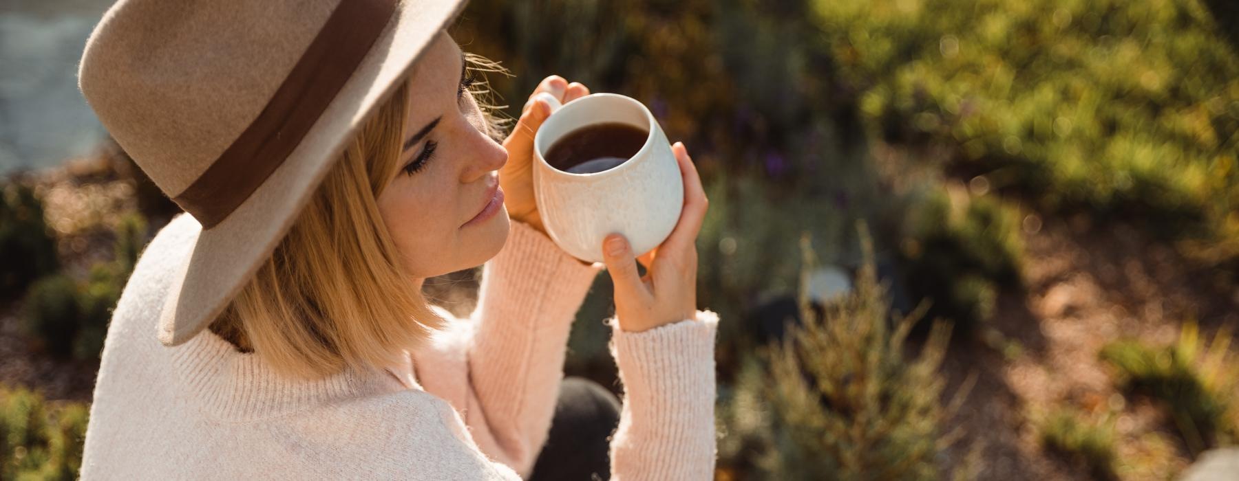 a person holding a cup of coffee